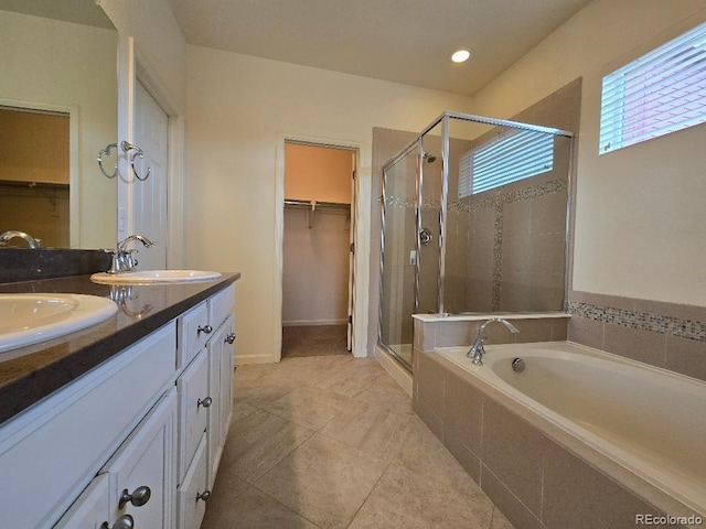 483 W 172nd Pl, Broomfield, CO 80023 - bathroom with a stall shower, a spacious closet, double vanity, a bath, and recessed lighting
