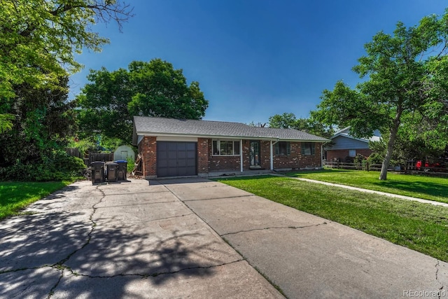 7479 Pierce St, Arvada, CO 80003 - single story home with a garage, brick siding, concrete driveway, and a porch