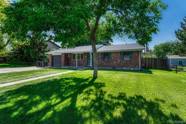 7479 Pierce St, Arvada, CO 80003 - single story home with driveway, brick siding, and an attached garage