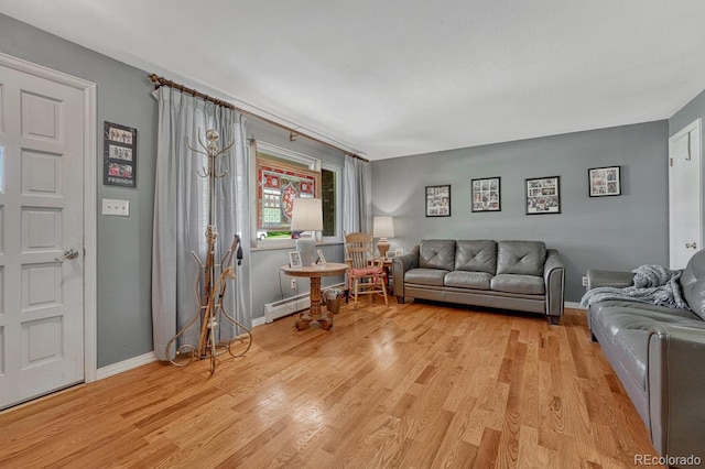 7479 Pierce St, Arvada, CO 80003 - living area featuring light wood-style flooring and a baseboard heating unit