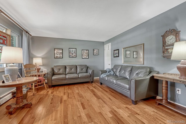 7479 Pierce St, Arvada, CO 80003 - living area with light wood finished floors and a baseboard heating unit