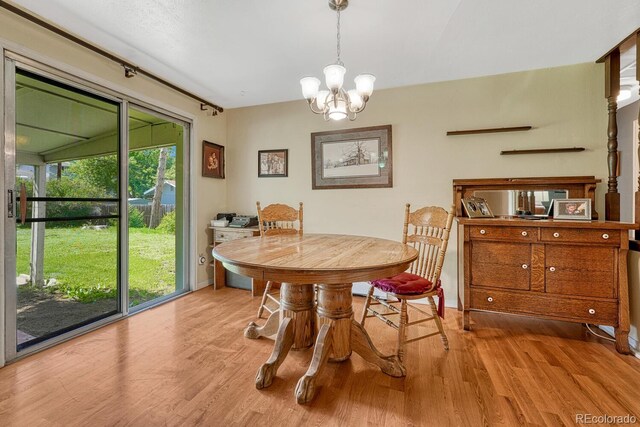 7479 Pierce St, Arvada, CO 80003 - dining area with light wood finished floors and a chandelier