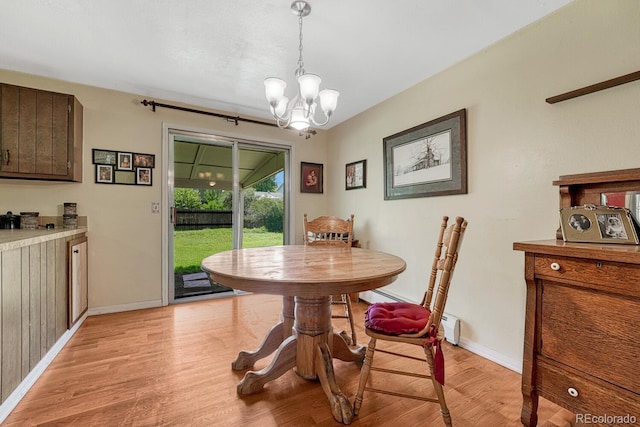 7479 Pierce St, Arvada, CO 80003 - dining area featuring light wood-type flooring and a chandelier