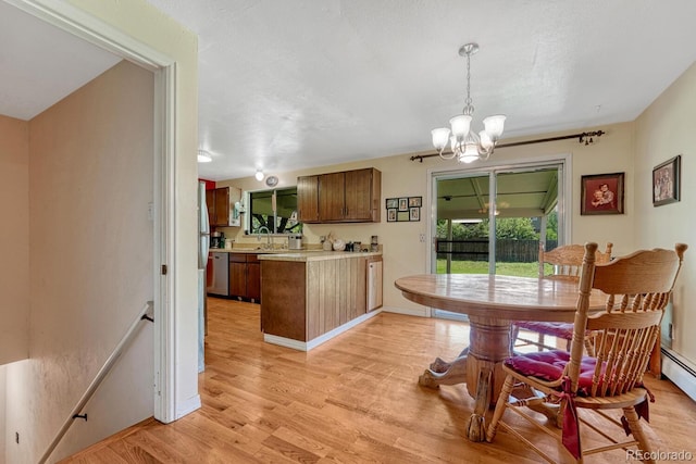 7479 Pierce St, Arvada, CO 80003 - dining room featuring a chandelier and light wood-style floors