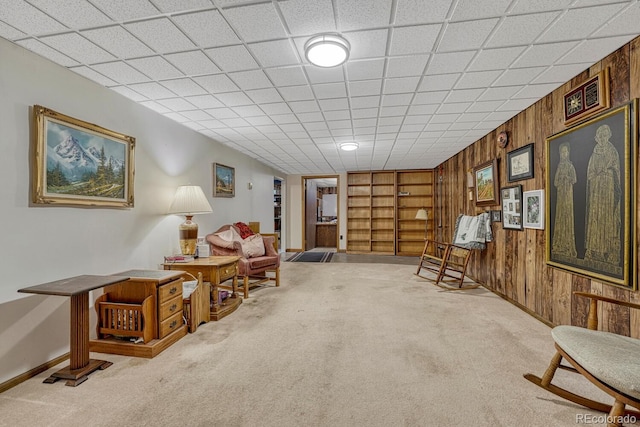 7479 Pierce St, Arvada, CO 80003 - sitting room featuring carpet, wooden walls, and built in shelves