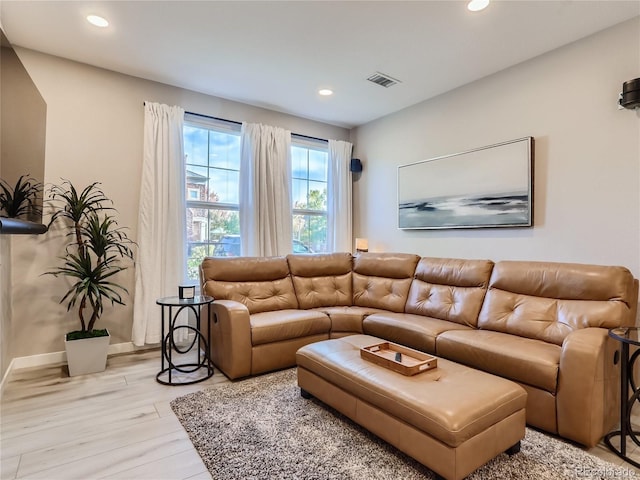 living room featuring recessed lighting, baseboards, visible vents, and light wood finished floors