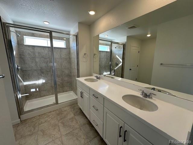 17719 Prairie Peak Trl, Parker, CO 80134 - full bath featuring a shower stall, double vanity, healthy amount of natural light, tile patterned flooring, and recessed lighting