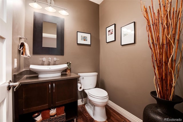 bathroom featuring hardwood / wood-style flooring, vanity, and toilet