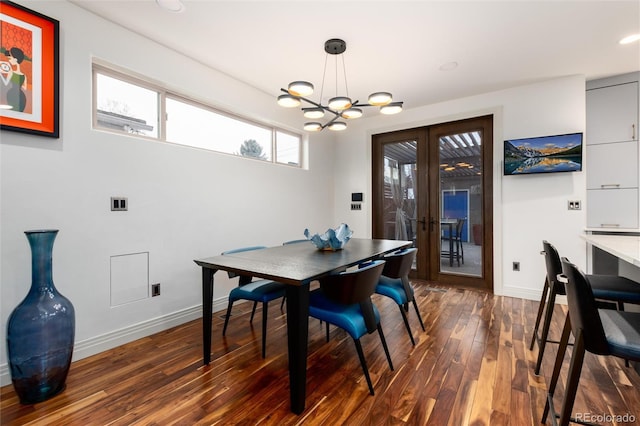 dining room featuring an inviting chandelier, dark hardwood / wood-style flooring, and french doors