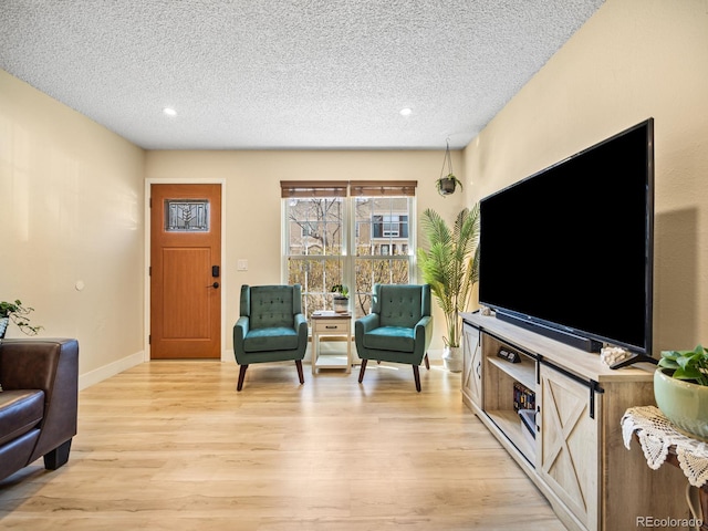 1247 S Idalia St, Aurora, CO 80017 - living room featuring light wood finished floors, a textured ceiling, baseboards, and recessed lighting