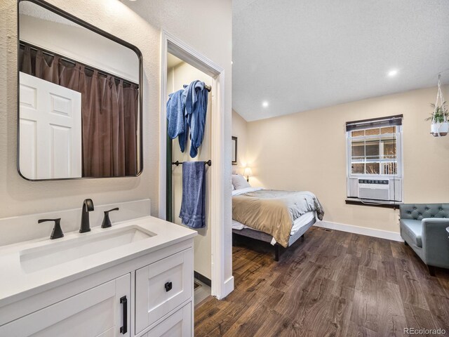 1247 S Idalia St, Aurora, CO 80017 - bedroom with a sink, dark wood finished floors, cooling unit, baseboards, and recessed lighting