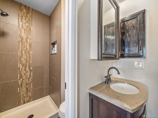 1247 S Idalia St, Aurora, CO 80017 - full bathroom with a stall shower, toilet, vanity, and a textured wall