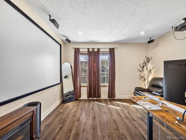 1247 S Idalia St, Aurora, CO 80017 - cinema room featuring a textured ceiling, wood finished floors, baseboards, and recessed lighting