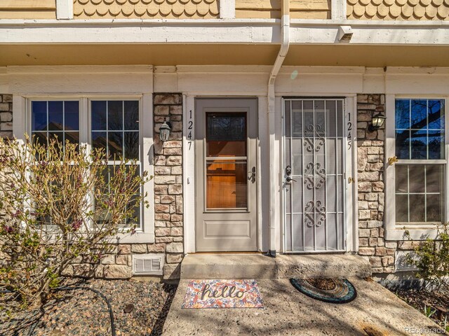 1247 S Idalia St, Aurora, CO 80017 - view of exterior entry featuring stone siding