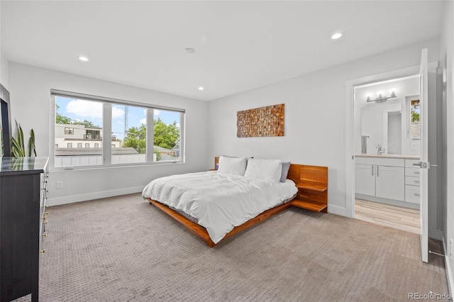 carpeted bedroom featuring connected bathroom