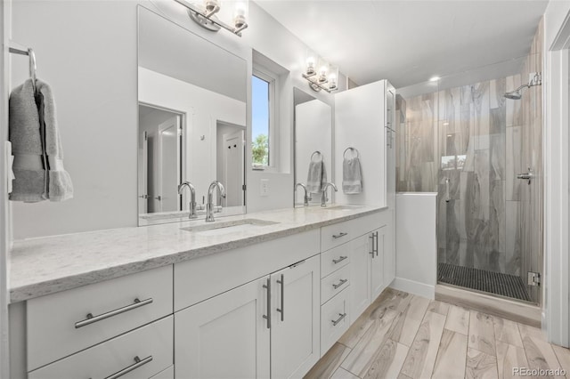 bathroom with vanity, hardwood / wood-style floors, and an enclosed shower