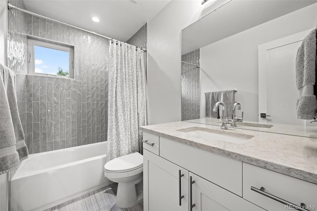 full bathroom featuring vanity, shower / bathtub combination with curtain, and toilet