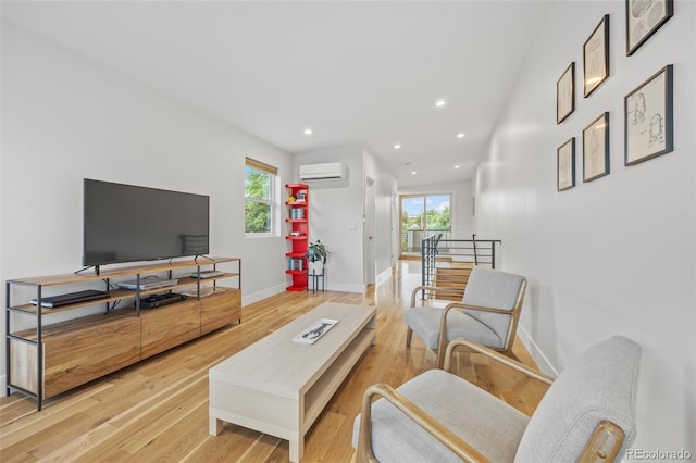 living room with hardwood / wood-style flooring and a wall unit AC