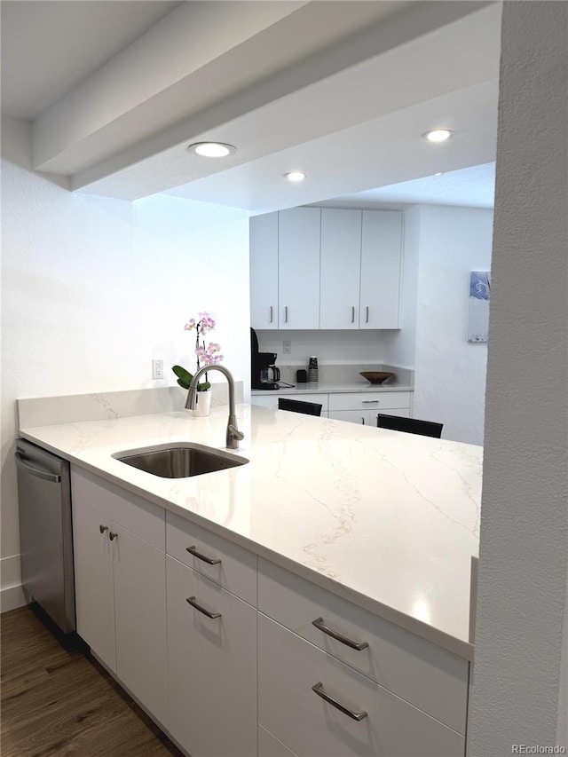 kitchen featuring dark wood-type flooring, sink, white cabinetry, light stone counters, and dishwasher