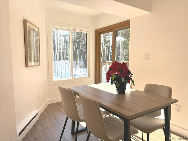 dining space featuring hardwood / wood-style flooring and a baseboard radiator