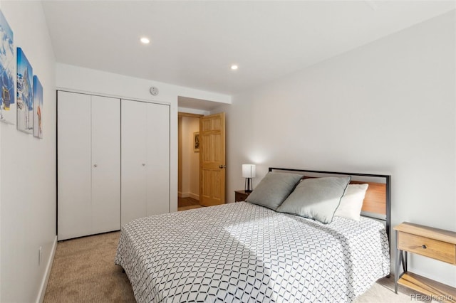 bedroom with light colored carpet and a closet