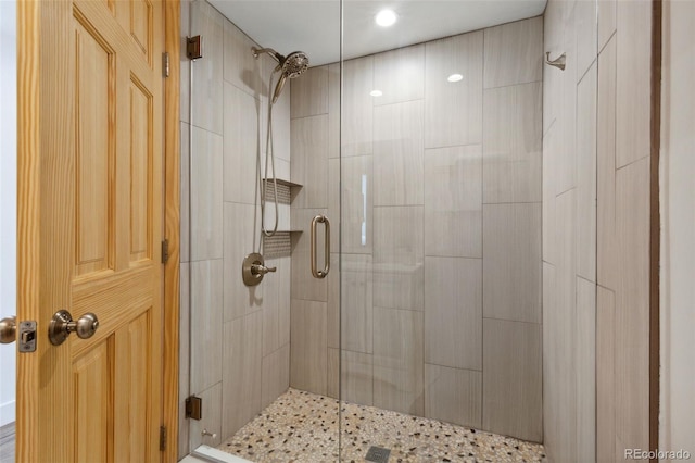 bathroom with a shower with door