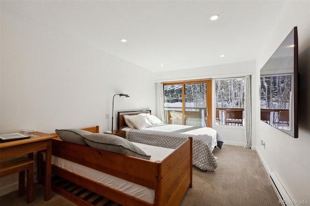 bedroom featuring baseboard heating and carpet