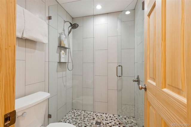 bathroom featuring an enclosed shower and toilet