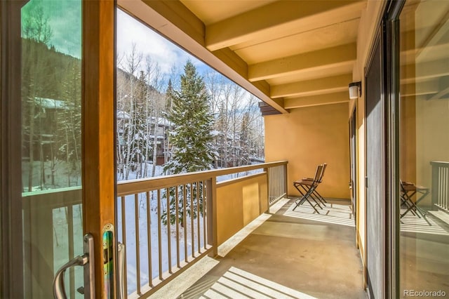 snow covered back of property featuring french doors