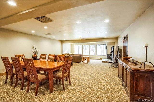 carpeted dining space with a baseboard radiator