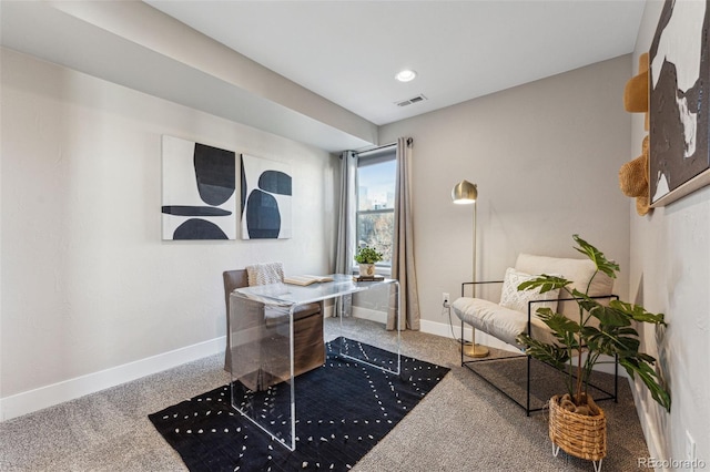 carpeted office space with visible vents and baseboards