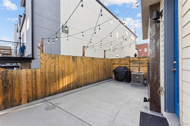 view of patio featuring a grill, fence, and cooling unit