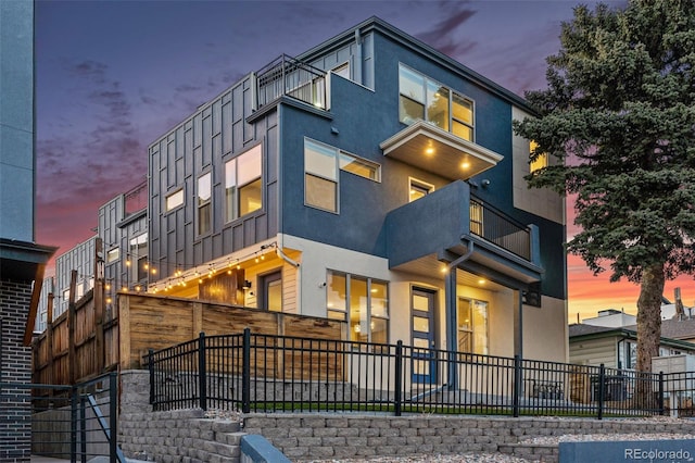 view of front facade featuring fence and stucco siding