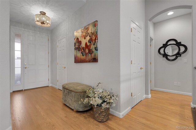 1033 Bramblewood Dr, Castle Pines, CO 80108 - foyer with arched walkways and wood finished floors