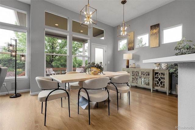 1033 Bramblewood Dr, Castle Pines, CO 80108 - dining space with light wood-style floors and a chandelier