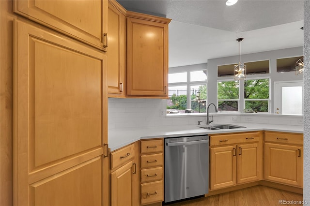 1033 Bramblewood Dr, Castle Pines, CO 80108 - kitchen featuring stainless steel dishwasher, plenty of natural light, light wood-style floors, and light countertops