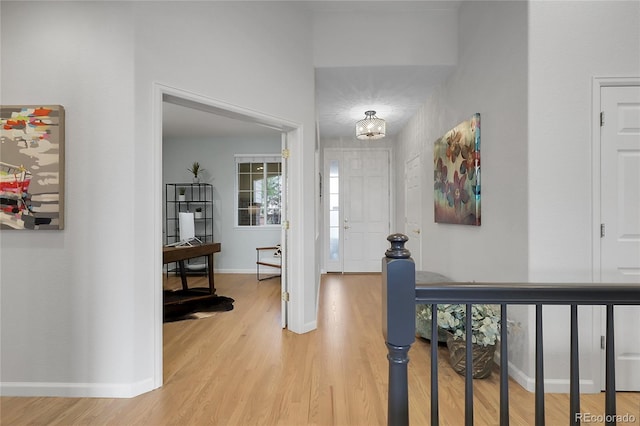 1033 Bramblewood Dr, Castle Pines, CO 80108 - entryway with light wood-style floors and a chandelier