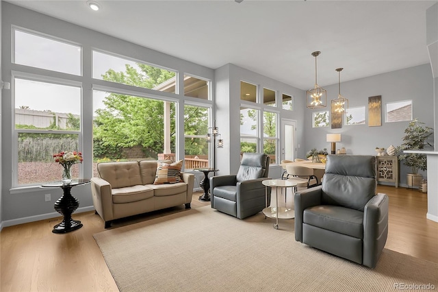 1033 Bramblewood Dr, Castle Pines, CO 80108 - living room with plenty of natural light, wood finished floors, and a chandelier