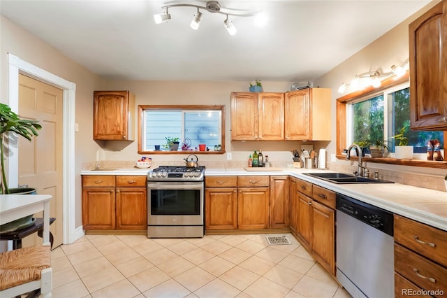 4210 S Fox St, Englewood, CO 80110 - kitchen with appliances with stainless steel finishes, a sink, and light countertops