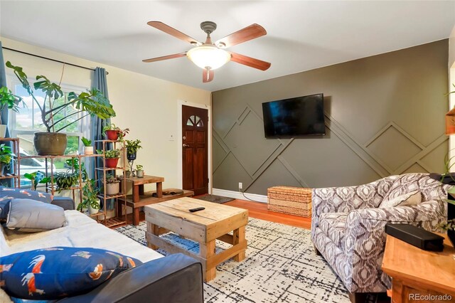 4210 S Fox St, Englewood, CO 80110 - living area with ceiling fan, a decorative wall, and light wood finished floors