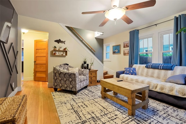 4210 S Fox St, Englewood, CO 80110 - living area with stairs, a ceiling fan, light wood-style floors, and baseboards