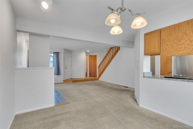 8911 W Yale Ave, Lakewood, CO 80227 - interior space featuring baseboards, stairway, and light colored carpet