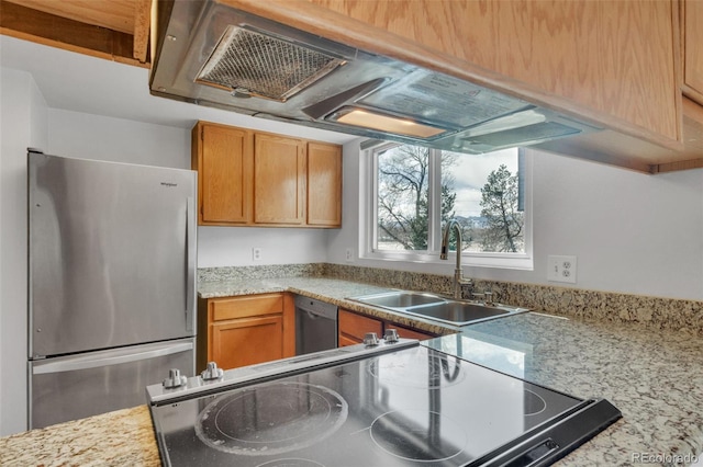 8911 W Yale Ave, Lakewood, CO 80227 - kitchen with appliances with stainless steel finishes, brown cabinets, a sink, and light stone countertops