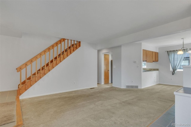 8911 W Yale Ave, Lakewood, CO 80227 - living room with stairway, visible vents, light carpet, and baseboards