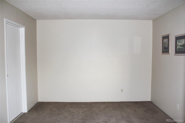 carpeted spare room with a textured ceiling