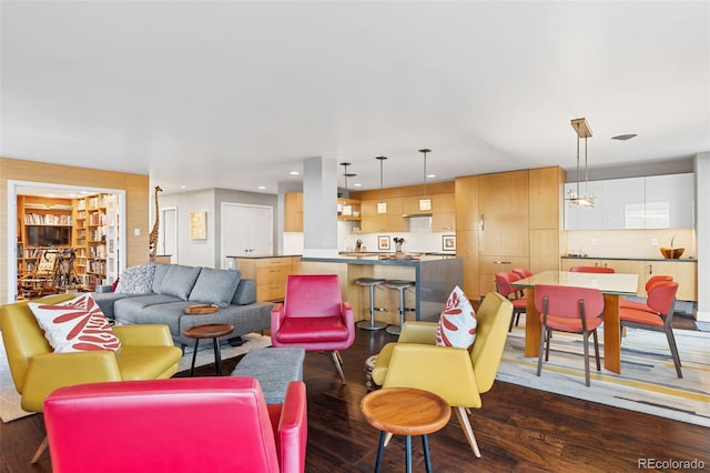 living area featuring recessed lighting and dark wood-style flooring