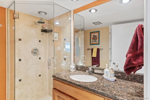 full bath featuring recessed lighting, vanity, and a shower stall