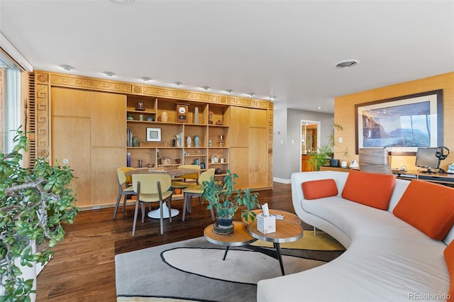 living room featuring visible vents and dark wood-style flooring