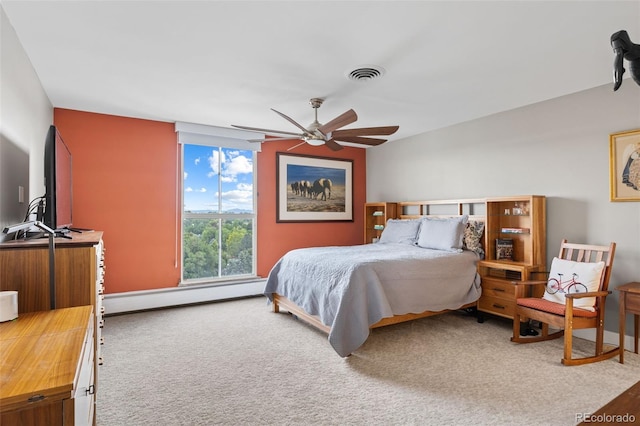 carpeted bedroom with a baseboard radiator, visible vents, and ceiling fan