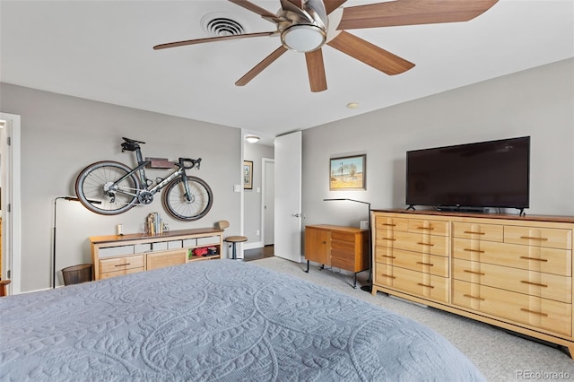 carpeted bedroom featuring visible vents and ceiling fan